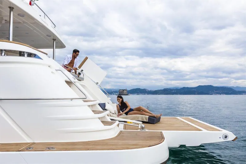  Yacht Photos Pics Luxury yacht Custom Line Navetta 28, 2020 model, with people relaxing on deck.