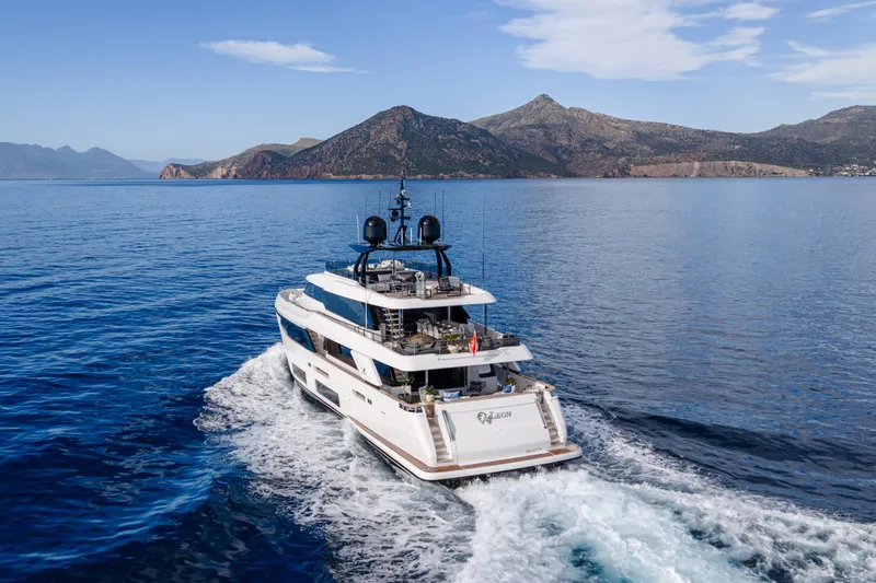 4leon Yacht Photos Pics Luxurious 2020 Custom Line Navetta 33 yacht cruising in scenic coastal waters.
