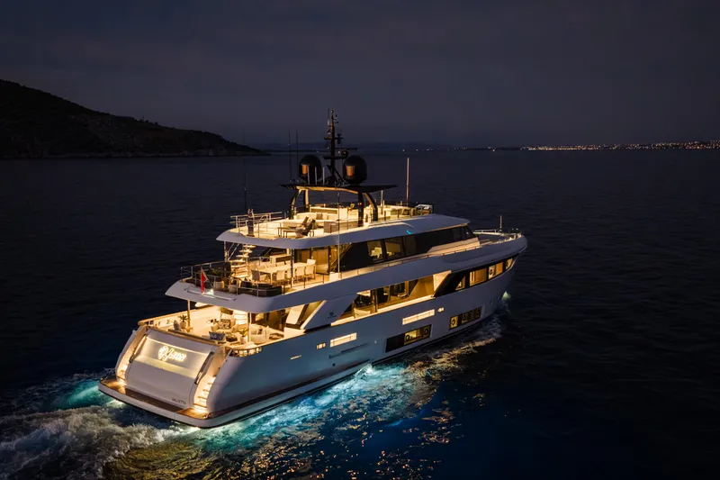4leon Yacht Photos Pics Luxurious 2020 Custom Line Navetta 33 yacht illuminated at night on the open sea.
