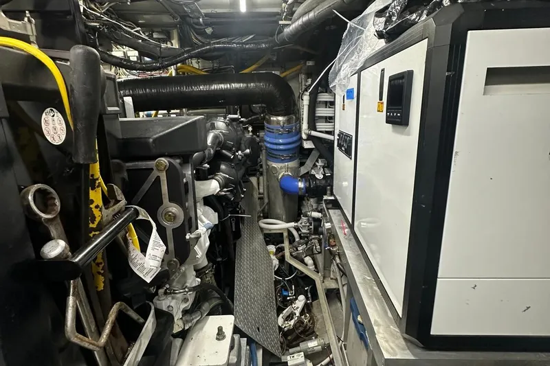 Adventurer Yacht Photos Pics Engine room of a 1985 Burger 94 yacht, showcasing complex machinery and wiring.