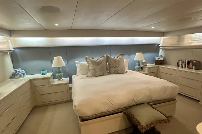 Adventurer Yacht Photos Pics Luxurious bedroom on 1985 Burger 94 yacht with elegant decor and ambient lighting.
