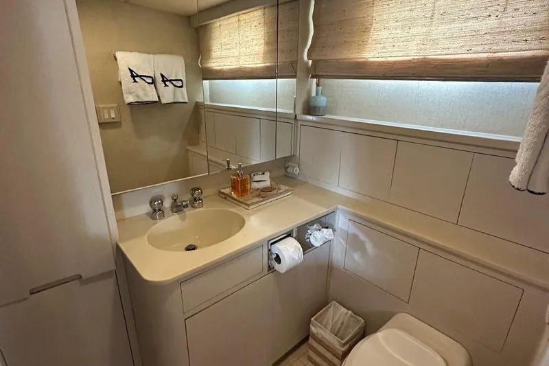 Adventurer Yacht Photos Pics Luxurious bathroom in 1985 Burger 94 yacht with elegant fixtures and natural lighting.