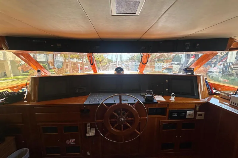 Adventurer Yacht Photos Pics Interior view of a 1985 Burger 94 yacht helm with wooden steering wheel and navigation equipment.