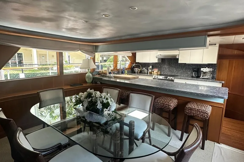 Adventurer Yacht Photos Pics Luxurious 1985 Burger 94 yacht interior with elegant dining area and modern kitchen.