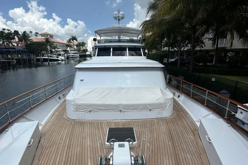 Adventurer Yacht Photos Pics Luxury 1985 Burger 94 yacht docked, featuring spacious wooden deck and sleek design.