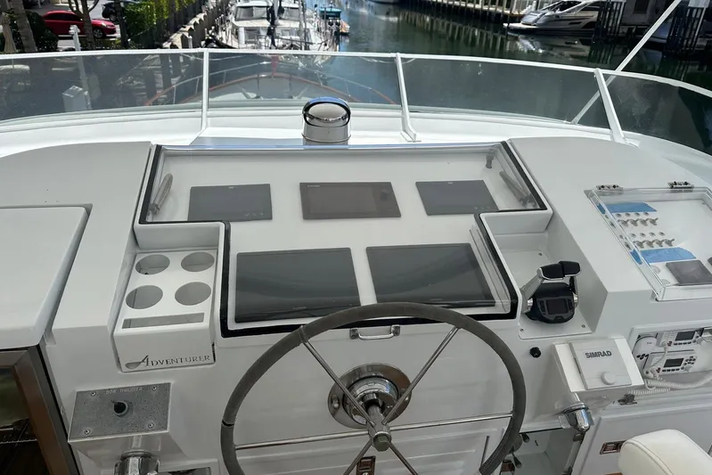 Adventurer Yacht Photos Pics Helm of 1985 Burger 94 yacht with modern navigation equipment and steering wheel.