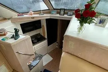 Sea Trial Yacht Photos Pics Interior of 1991 Hatteras 40 Motor Yacht with kitchen and floral decor.