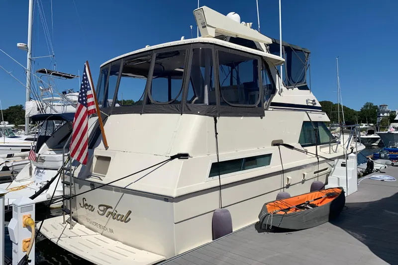 Sea Trial Yacht Photos Pics 1991 Hatteras 40 Motor Yacht docked, featuring American flag and kayak on deck.
