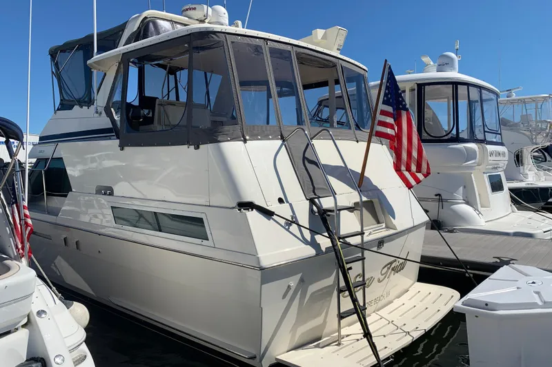 Sea Trial Yacht Photos Pics 1991 Hatteras 40 Motor Yacht docked with American flag, sunny day.