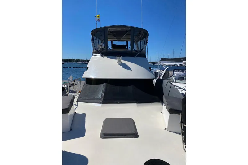 Sea Trial Yacht Photos Pics 1991 Hatteras 40 Motor Yacht docked, featuring spacious deck and covered helm area.