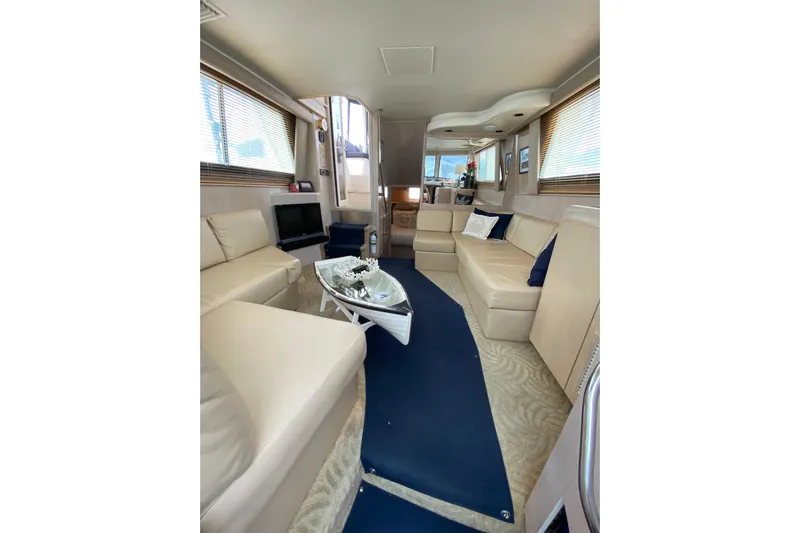 Sea Trial Yacht Photos Pics Luxurious interior of a 1991 Hatteras 40 Motor Yacht with beige seating and modern decor.