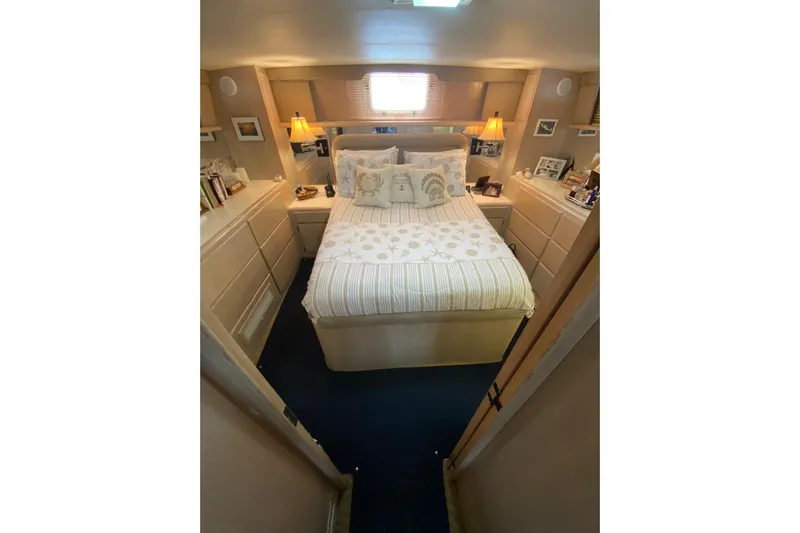 Sea Trial Yacht Photos Pics Cozy bedroom in 1991 Hatteras 40 Motor Yacht with elegant decor and soft lighting.