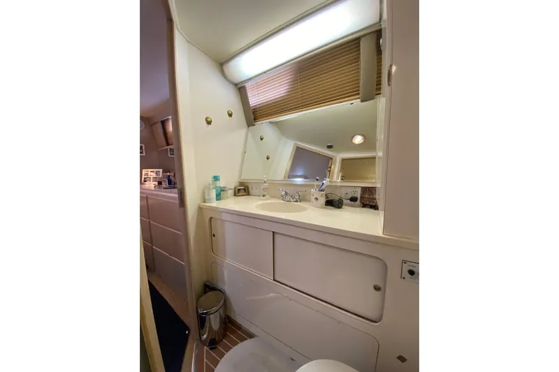 Sea Trial Yacht Photos Pics Bathroom interior of 1991 Hatteras 40 Motor Yacht with sink and mirror.