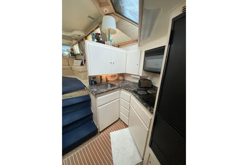 Sea Trial Yacht Photos Pics Interior of 1991 Hatteras 40 Motor Yacht kitchen with modern appliances and sleek design.