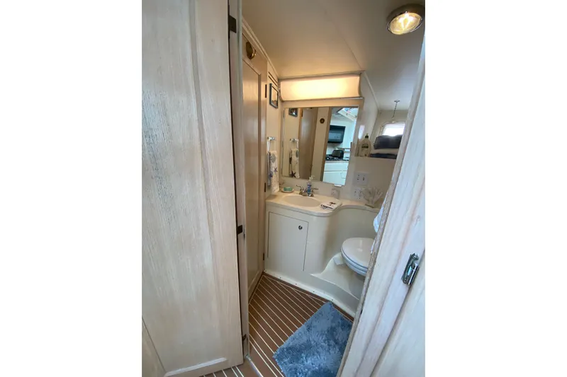 Sea Trial Yacht Photos Pics Bathroom interior of 1991 Hatteras 40 Motor Yacht with wooden accents and modern fixtures.