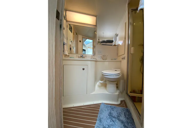 Sea Trial Yacht Photos Pics Bathroom interior of 1991 Hatteras 40 Motor Yacht with shower and toilet.