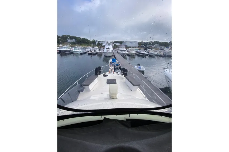 Sea Trial Yacht Photos Pics 1991 Hatteras 40 Motor Yacht docked at a marina on a rainy day.