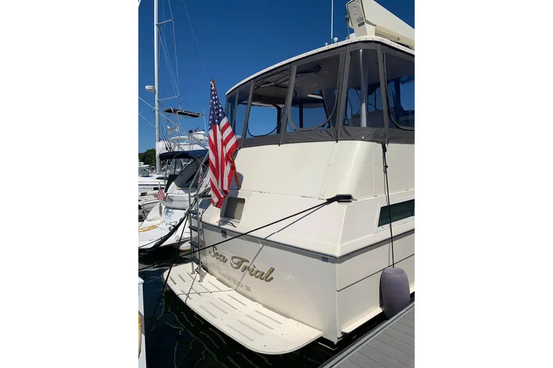 Sea Trial Yacht Photos Pics 1991 Hatteras 40 Motor Yacht docked with American flag displayed.