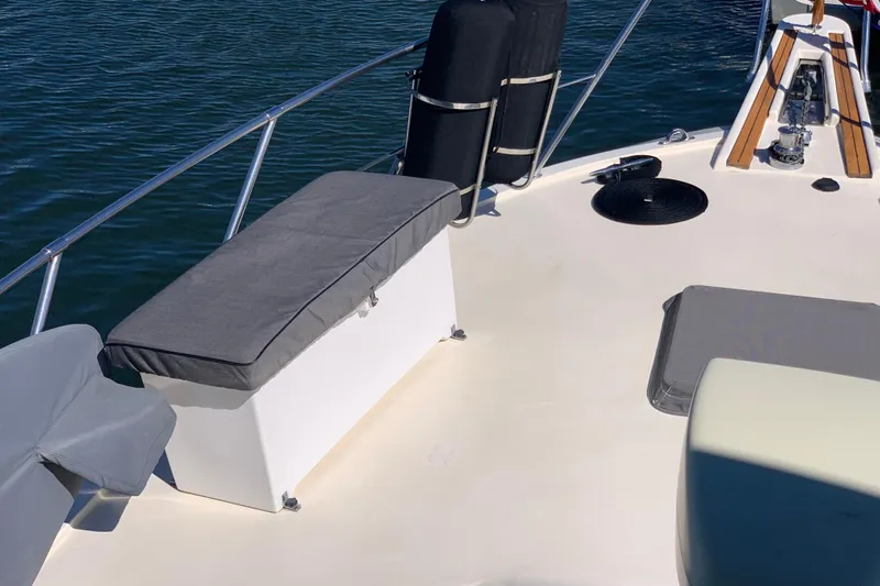 Sea Trial Yacht Photos Pics 1991 Hatteras 40 Motor Yacht deck with seating and railing, on calm water.