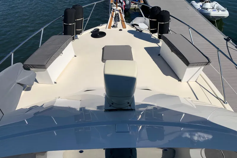 Sea Trial Yacht Photos Pics 1991 Hatteras 40 Motor Yacht deck with cushioned seating and dock view.