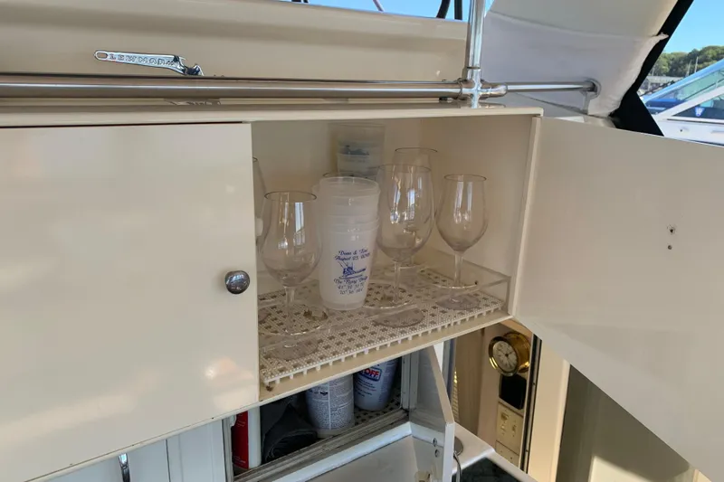 Sea Trial Yacht Photos Pics Cabinet with glasses and cups on 1991 Hatteras 40 Motor Yacht.