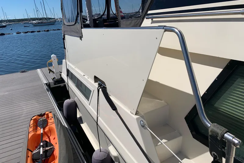 Sea Trial Yacht Photos Pics 1991 Hatteras 40 Motor Yacht docked with kayak, sunny marina view.