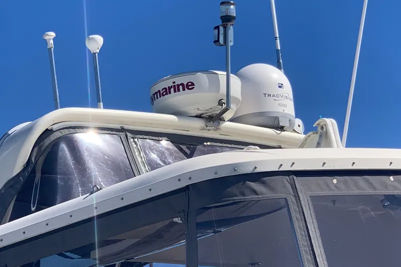 Sea Trial Yacht Photos Pics 1991 Hatteras 40 Motor Yacht with radar and satellite equipment under clear blue sky.