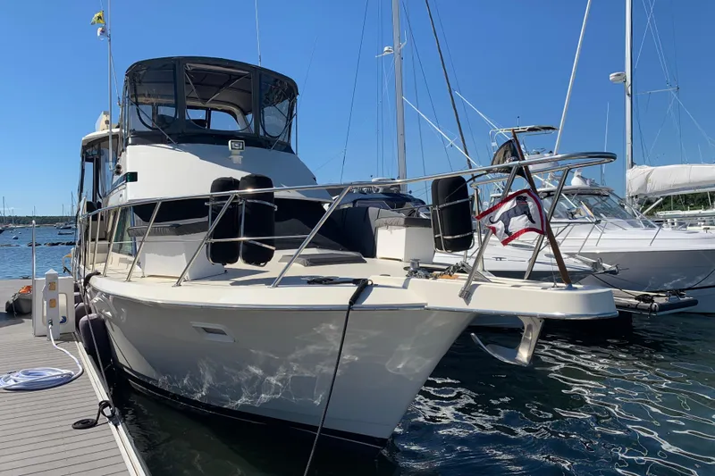 Sea Trial Yacht Photos Pics 1991 Hatteras 40 Motor Yacht docked at marina on a sunny day.