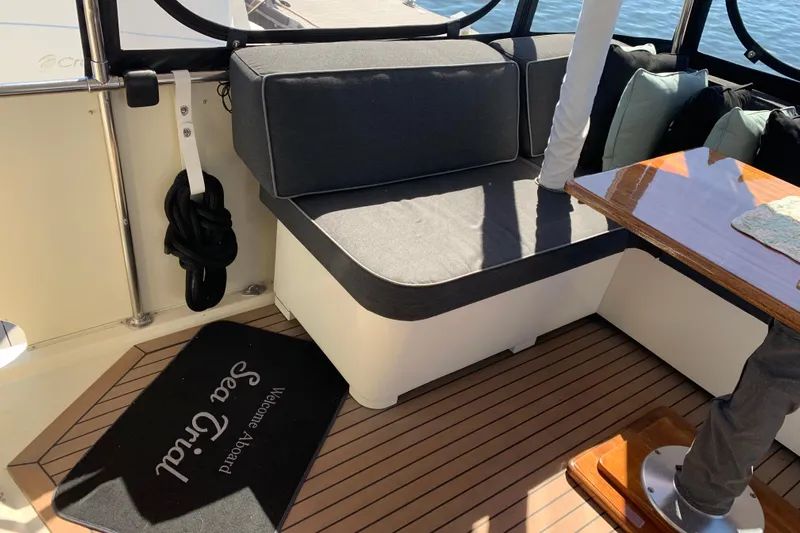 Sea Trial Yacht Photos Pics Interior of 1991 Hatteras 40 Motor Yacht with seating and wooden table.