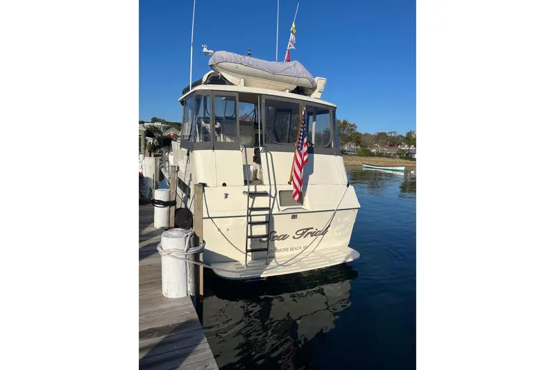 Sea Trial Yacht Photos Pics 1991 Hatteras 40 Motor Yacht docked, displaying American flag, clear blue sky.