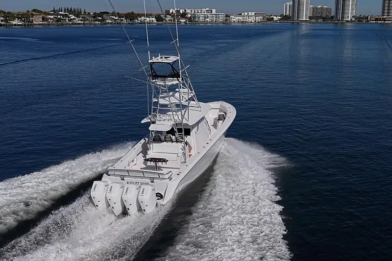 Yacht Photos Pics A 2025 Sparks 46 boat cruising on a calm blue waterway.