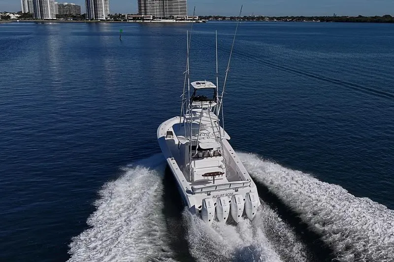  Yacht Photos Pics A 2025 Sparks 46 boat cruising on a calm waterway near city buildings.