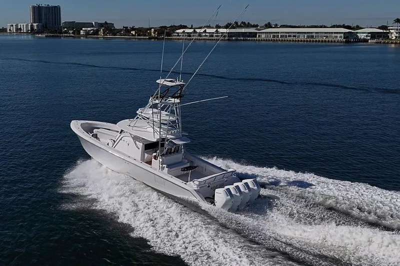  Yacht Photos Pics A 2025 Sparks 46 boat cruising on calm waters near a coastal city.
