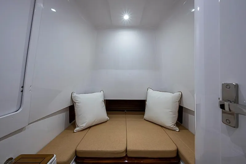  Yacht Photos Pics Compact cabin interior of Sparks 46, 2025 model, featuring cozy seating and soft lighting.