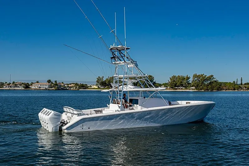  Yacht Photos Pics A sleek 2025 Sparks 46 boat cruising on a sunny day near a coastal area.