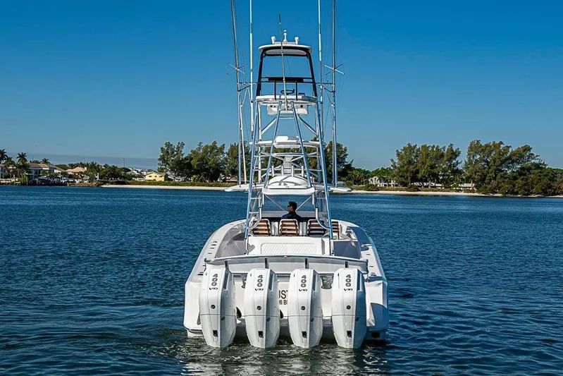  Yacht Photos Pics Sparks 46 boat, 2025 model, cruising on a serene lake with clear blue skies.