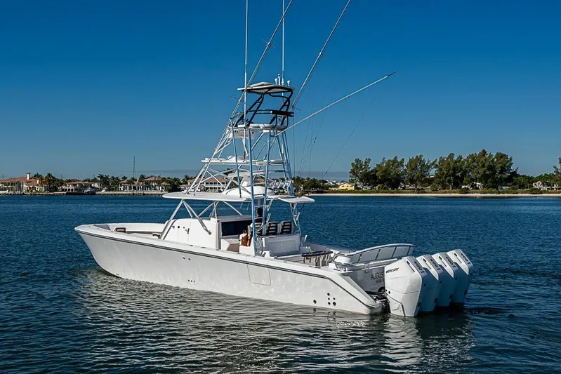  Yacht Photos Pics 2025 Sparks 46 boat with multiple engines on calm water, clear blue sky.
