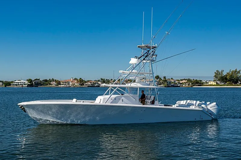  Yacht Photos Pics 2025 Sparks 46 yacht cruising on a sunny day near coastal homes.