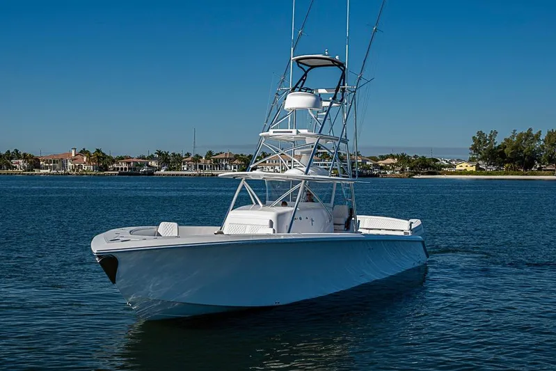  Yacht Photos Pics Sparks 46 boat, 2025 model, cruising on a calm blue waterway.