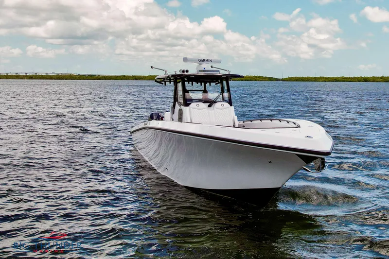  Yacht Photos Pics 2023 Fountain 38 TE boat cruising on open water under a partly cloudy sky.