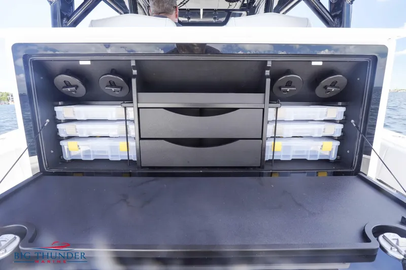  Yacht Photos Pics 2023 Fountain 38 TE storage compartment with organized tackle boxes.