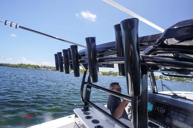  Yacht Photos Pics 2023 Fountain 38 TE boat on water with rod holders and console.