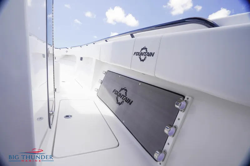  Yacht Photos Pics 2023 Fountain 38 TE boat interior with branding, white deck, and blue sky background.