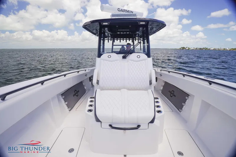  Yacht Photos Pics 2023 Fountain 38 TE boat interior with white seating on open water.