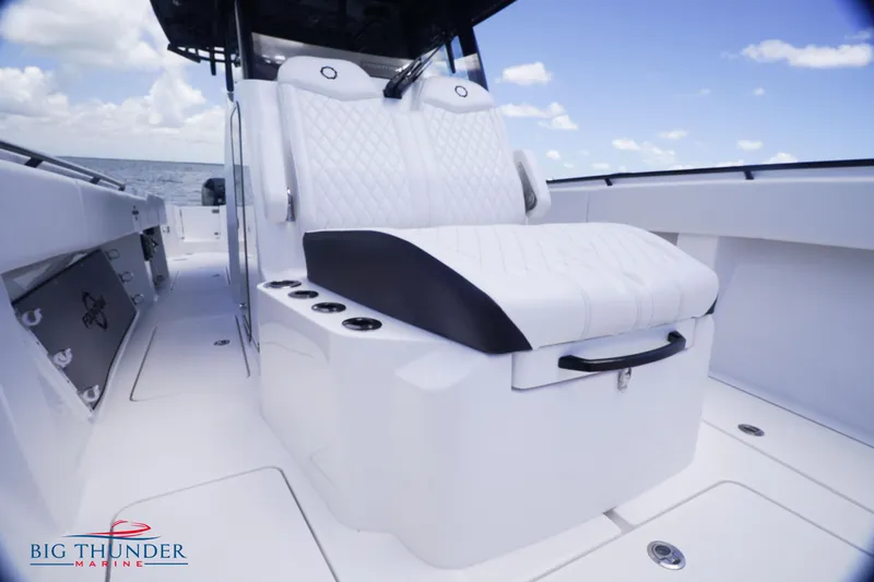  Yacht Photos Pics 2023 Fountain 38 TE boat interior with white seating and ocean backdrop.