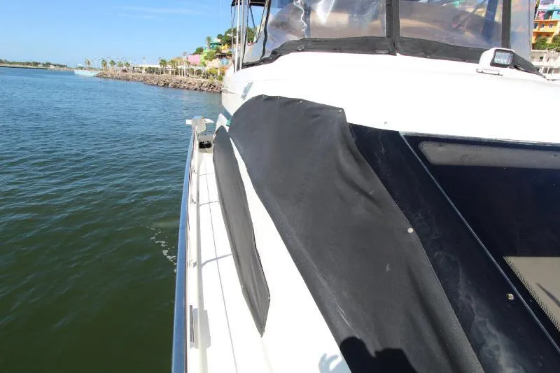  Yacht Photos Pics 1999 Azimut 58 yacht on calm water, showcasing sleek design and luxurious features.