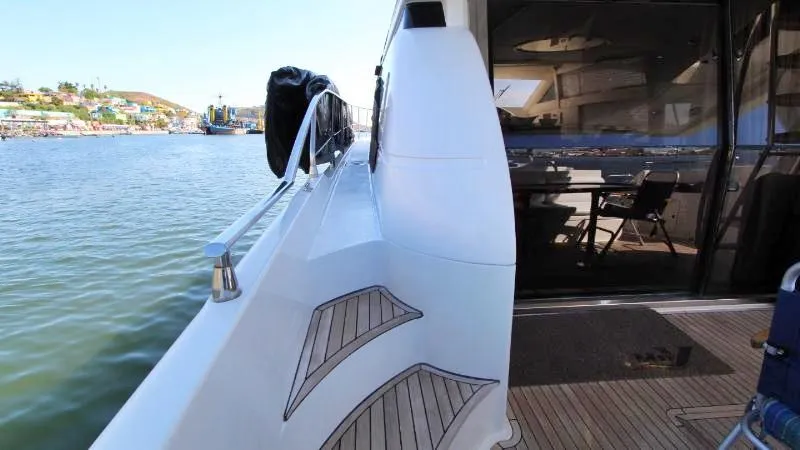  Yacht Photos Pics Side view of a 1999 Azimut 58 yacht docked by the water.