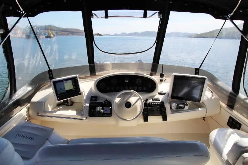  Yacht Photos Pics Cockpit of 1999 Azimut 58 yacht with navigation screens and steering wheel.