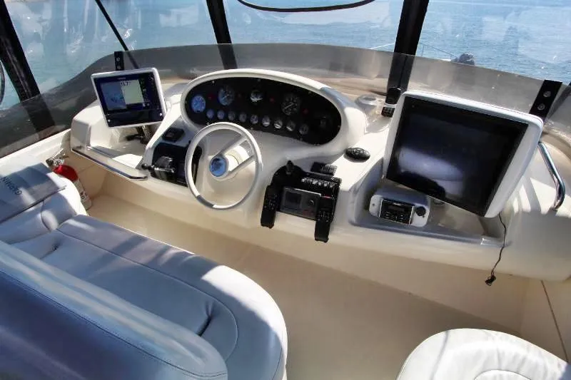  Yacht Photos Pics Cockpit of 1999 Azimut 58 yacht with modern navigation equipment and steering wheel.