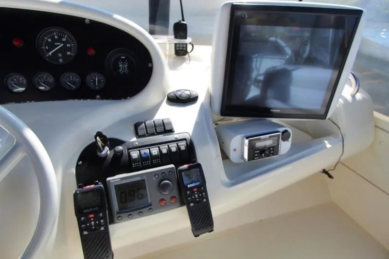  Yacht Photos Pics Control panel of a 1999 Azimut 58 yacht with navigation instruments and communication devices.